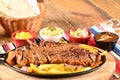 roast beef with seasonings and sliced Ã¢â¬â¹Ã¢â¬â¹barbecue salad served on plate on wooden table Royalty Free Stock Photo